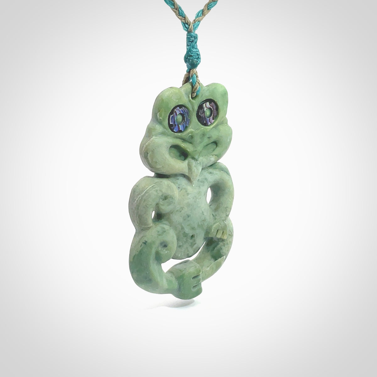 This is a large sized tiki - carved from gorgeous Marsden jade. The craftsmanship is superb, this piece is as well carved as any we have seen. The cord is an adjustable four plaited cord in black. One only by Ana Krakosky.