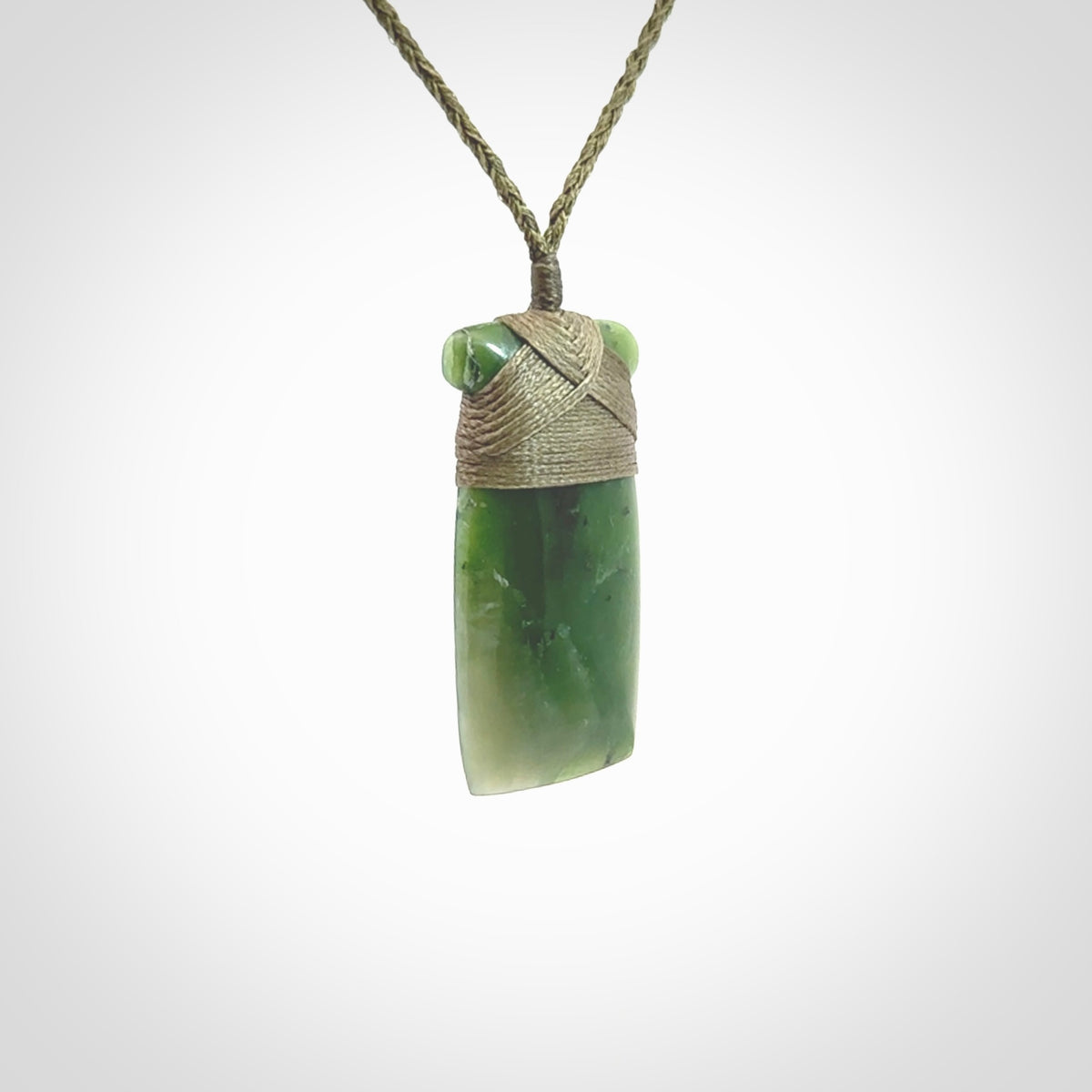 Hand carved jade toki pendant. Carved by NZ Pacific in green jade. Hand made Jade Toki necklace for men and women. Beautiful greenstone Toki with adjustable cord. Delivered to you with Express Courier.