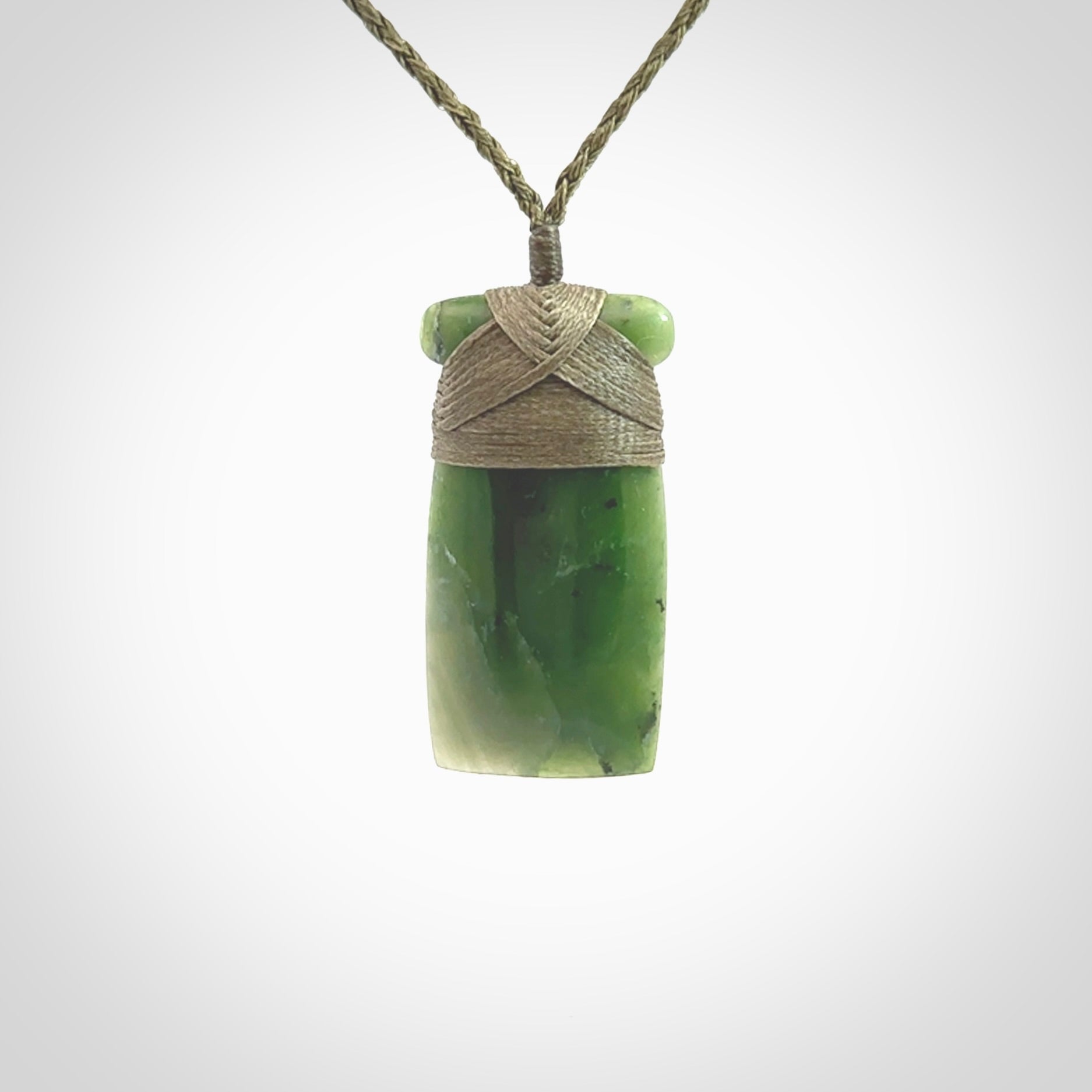 Hand carved jade toki pendant. Carved by NZ Pacific in green jade. Hand made Jade Toki necklace for men and women. Beautiful greenstone Toki with adjustable cord. Delivered to you with Express Courier.