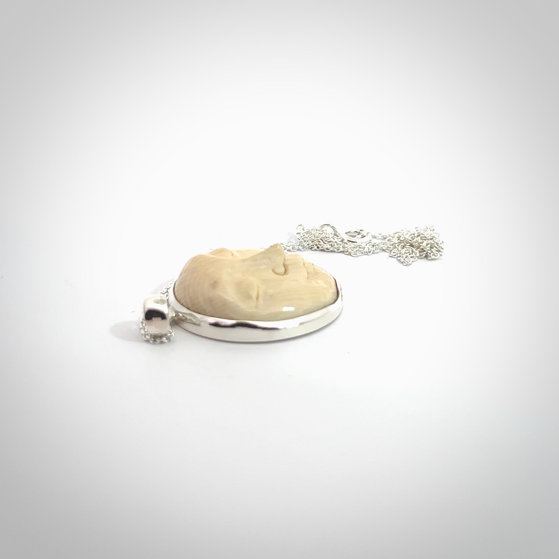 Hand made woolly mammoth tusk moon face necklace. Made by NZ Pacific and sale online only.