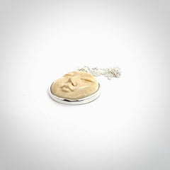 Hand made woolly mammoth tusk moon face necklace. Made by NZ Pacific and sale online only.