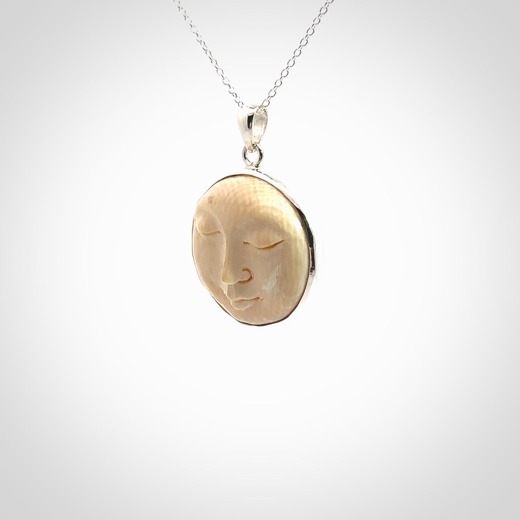 Hand made woolly mammoth tusk moon face necklace. Made by NZ Pacific and sale online only.