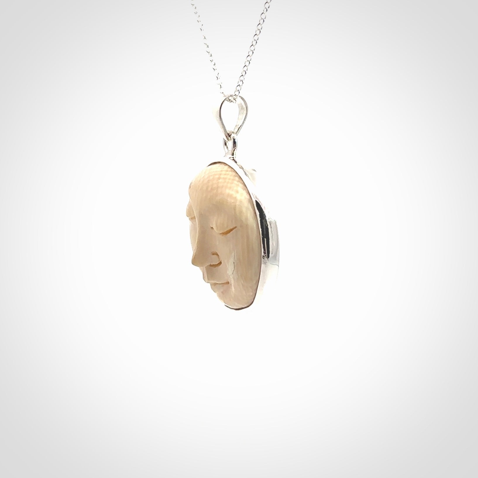 Hand made woolly mammoth tusk moon face necklace. Made by NZ Pacific and sale online only.