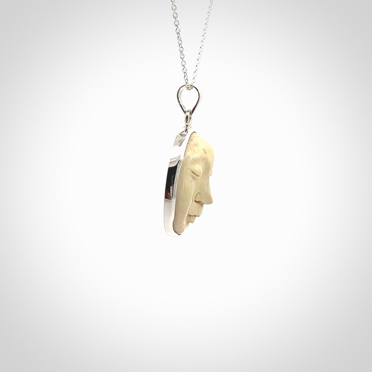 Hand made woolly mammoth tusk moon face necklace. Made by NZ Pacific and sale online only.