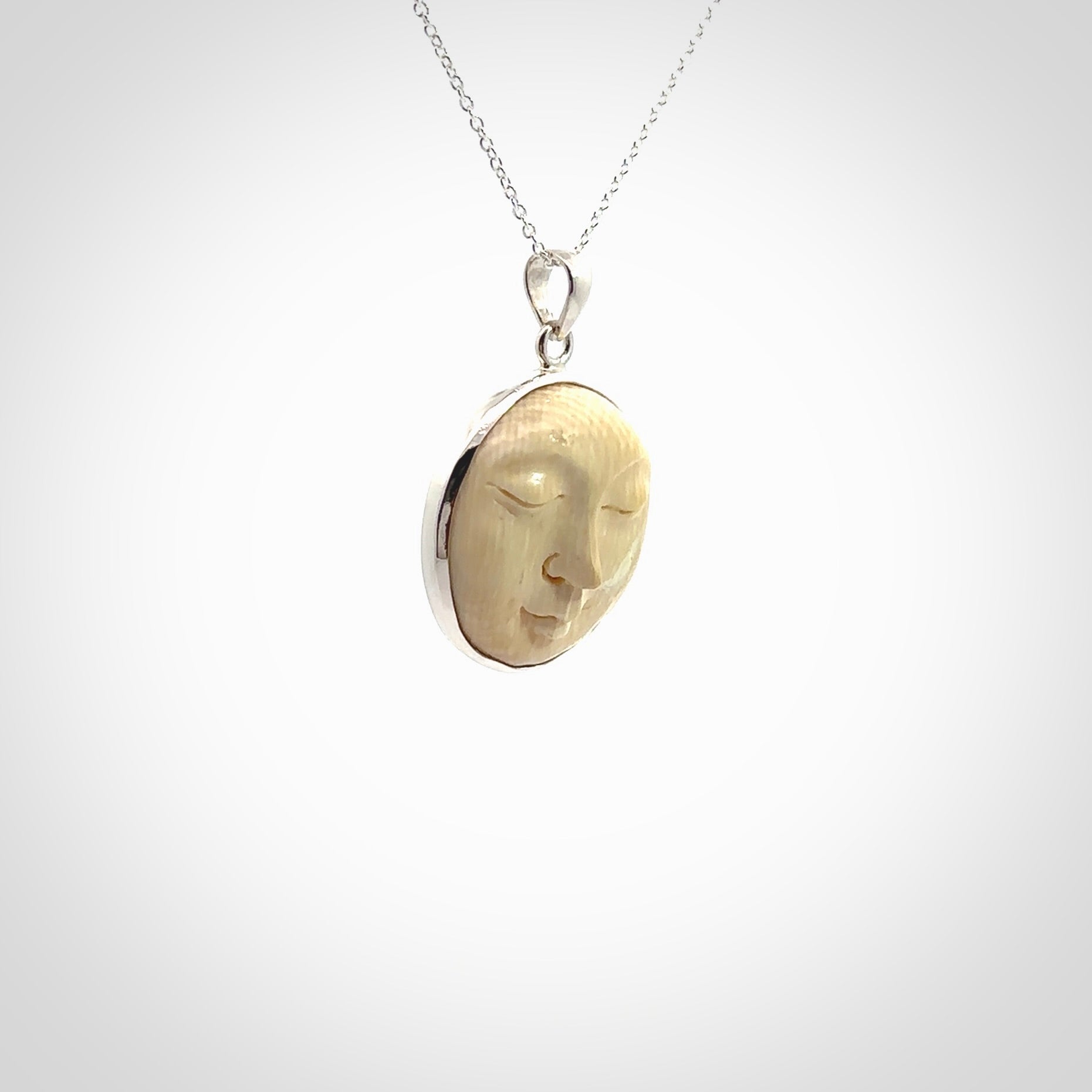 Hand made woolly mammoth tusk moon face necklace. Made by NZ Pacific and sale online only.