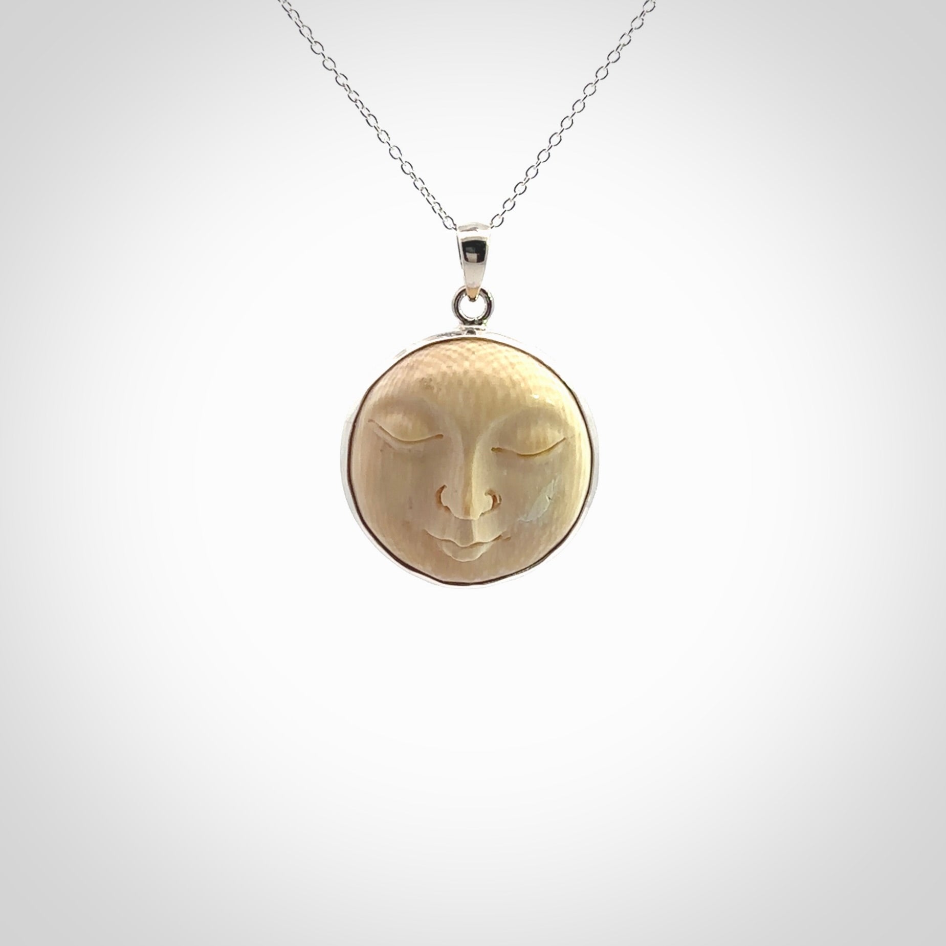 Hand made woolly mammoth tusk moon face necklace. Made by NZ Pacific and sale online only.