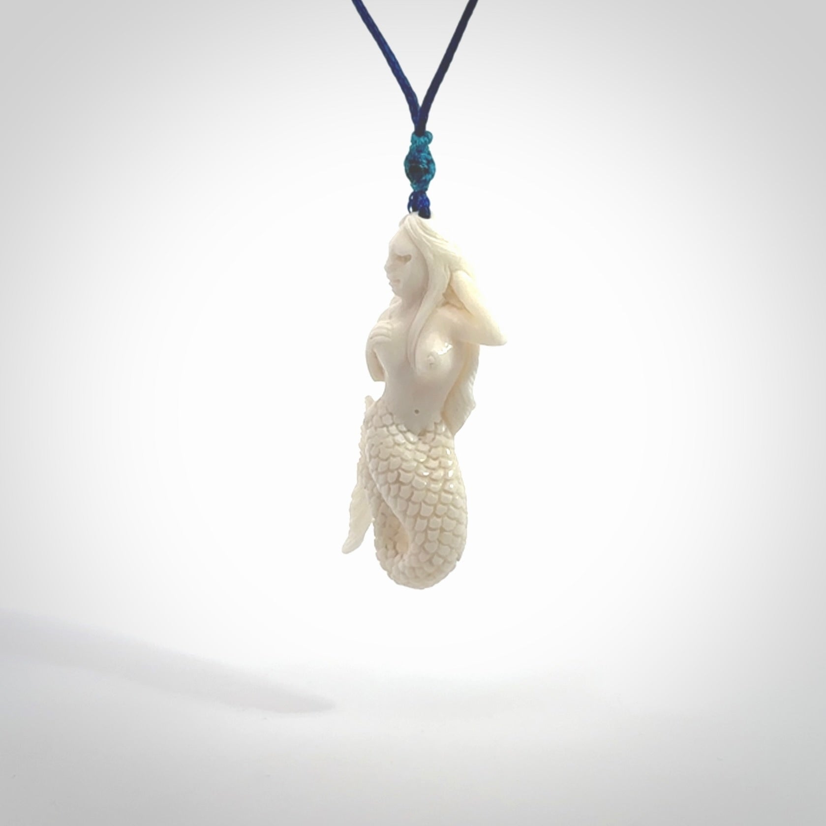 Hand carved natural bone mermaid pendant. Hand made from real bone. Art to wear. Provided with adjustable cord and packaged in a woven kete pouch.