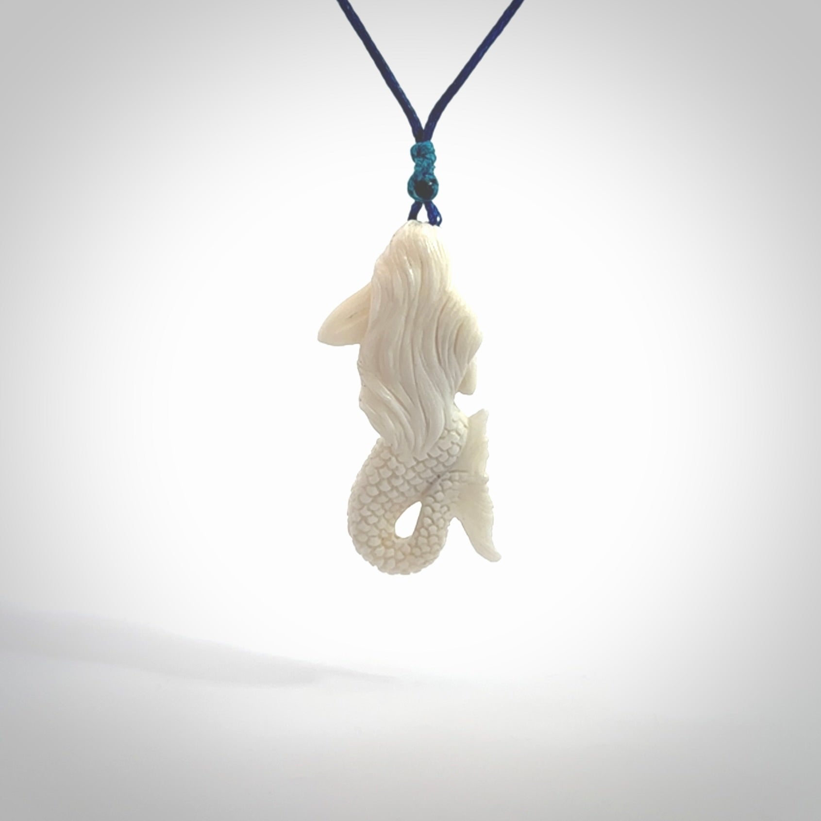 Hand carved natural bone mermaid pendant. Hand made from real bone. Art to wear. Provided with adjustable cord and packaged in a woven kete pouch.