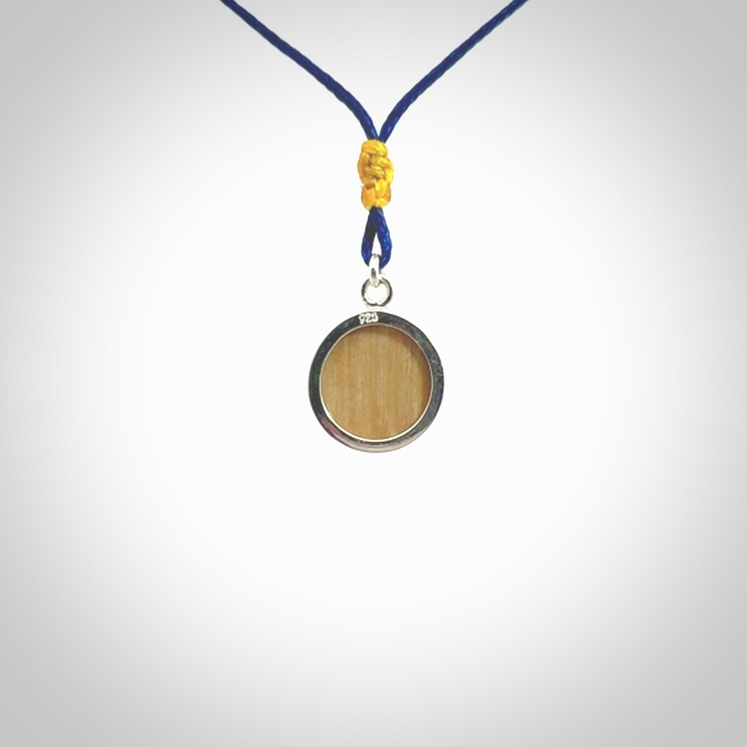 Hand made woolly mammoth tusk moon face necklace. Made by NZ Pacific and sale online only. Delivered with adjustable blue cord and packaged in a woven kete pouch.