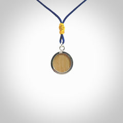 Hand made woolly mammoth tusk moon face necklace. Made by NZ Pacific and sale online only. Delivered with adjustable blue cord and packaged in a woven kete pouch.