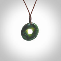 This little piece is a hand carved möbius ribbon pendant. We've carved this from New Zealand Jade. It has very subtle colour variations in the stone and is a delightful, small and artistic piece of jewellery. Hand made by Kyohei Noguchi and delivered to you in a kete pouch. Delivered to you on an adjustable brown cord.