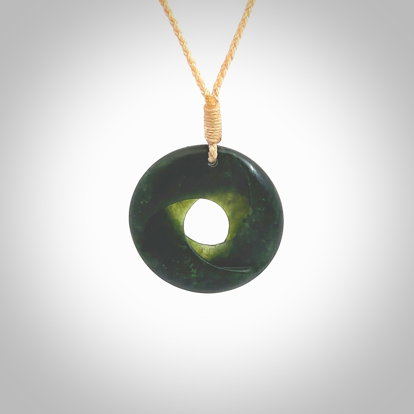 This small sized piece is a hand carved möbius ribbon pendant. Kyohei Noguchi has carved this from New Zealand Nephrite Jade. It has very subtle colour variations in the stone and is a delightful, small and artistic piece of jewellery. Delivered with an adjustable beige cord.