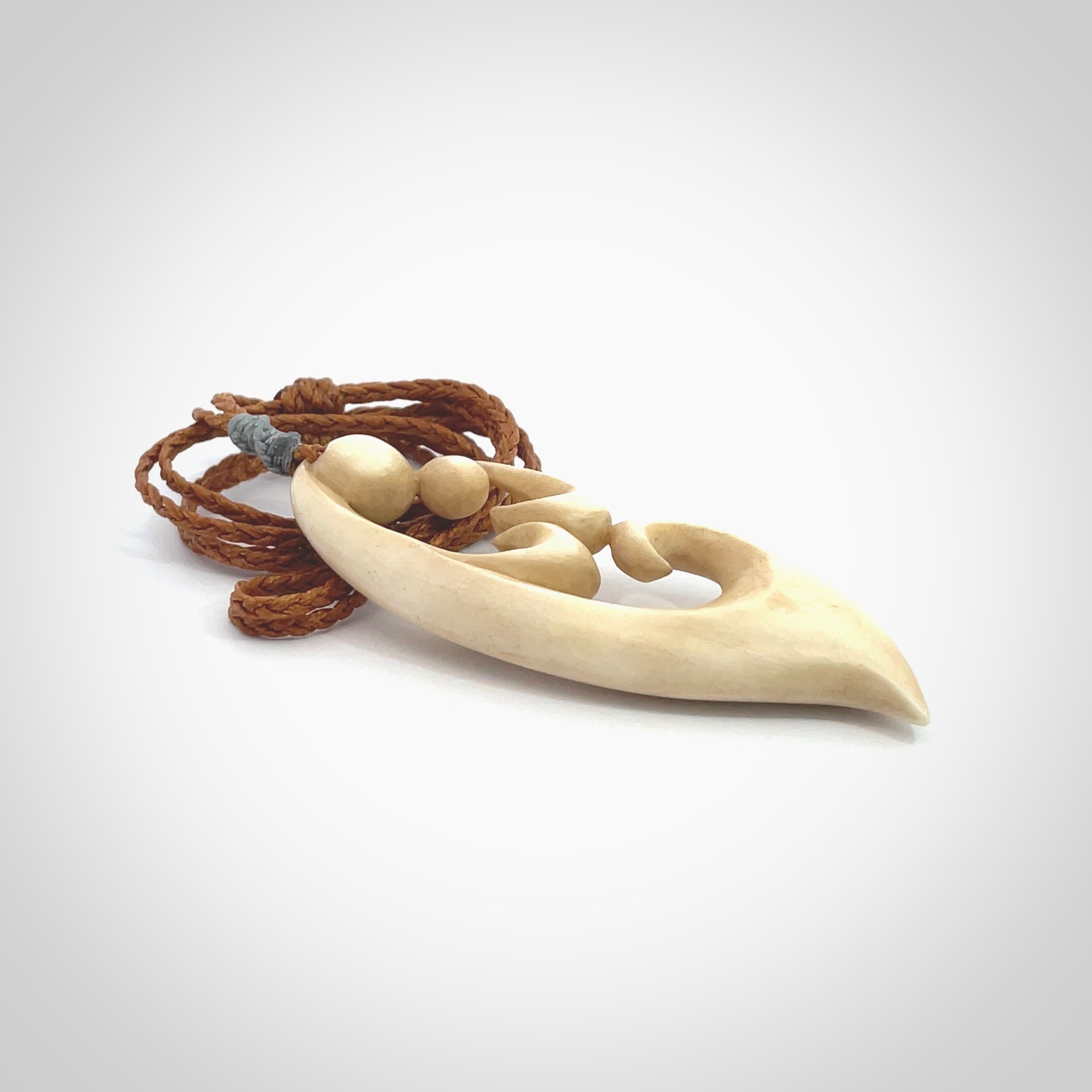 A hand carved masterpiece. A beautiful contemporary pendant carved from bone by Yuri Terenyi for NZ Pacific. This is a true piece of wearable art which is collectible. A one-off pendant representing a mother and child. Provided with an adjustable gingernut cord and packaged in a woven kete pouch.