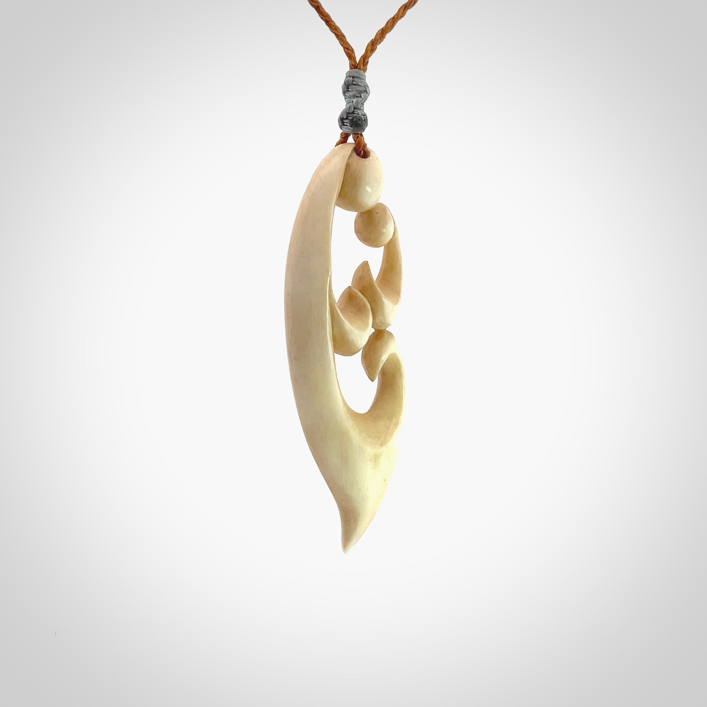 A hand carved masterpiece. A beautiful contemporary pendant carved from bone by Yuri Terenyi for NZ Pacific. This is a true piece of wearable art which is collectible. A one-off pendant representing a mother and child. Provided with an adjustable gingernut cord and packaged in a woven kete pouch.