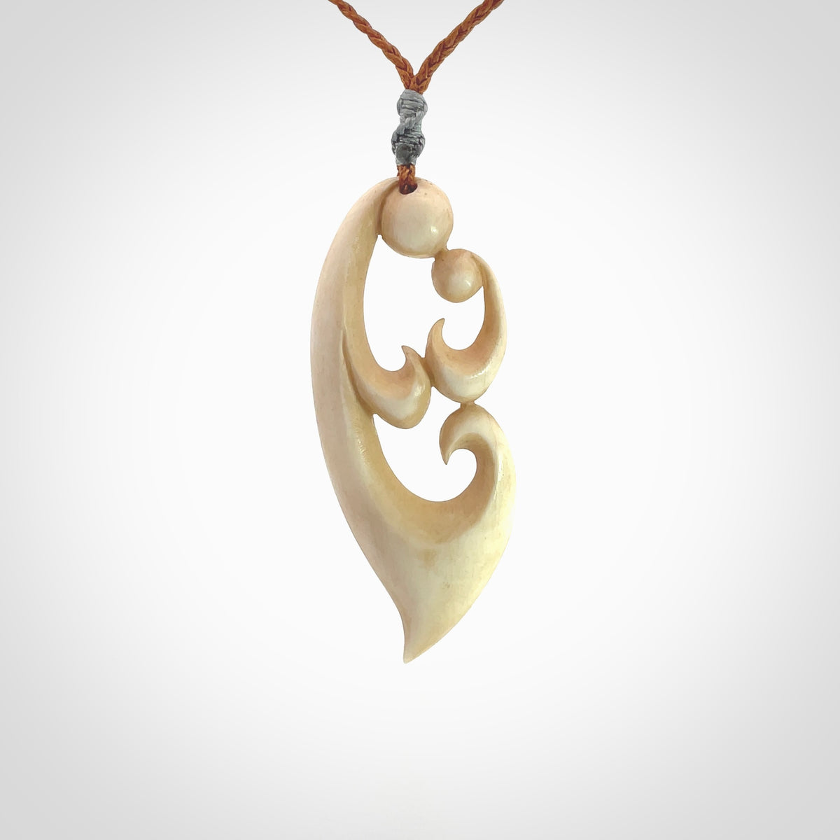 A hand carved masterpiece. A beautiful contemporary pendant carved from bone by Yuri Terenyi for NZ Pacific. This is a true piece of wearable art which is collectible. A one-off pendant representing a mother and child. Provided with an adjustable gingernut cord and packaged in a woven kete pouch.