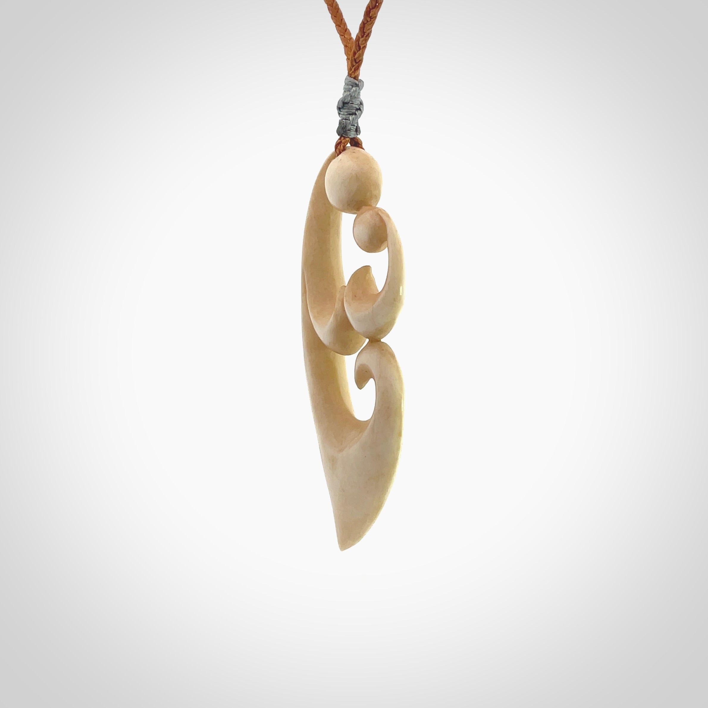 A hand carved masterpiece. A beautiful contemporary pendant carved from bone by Yuri Terenyi for NZ Pacific. This is a true piece of wearable art which is collectible. A one-off pendant representing a mother and child. Provided with an adjustable gingernut cord and packaged in a woven kete pouch.