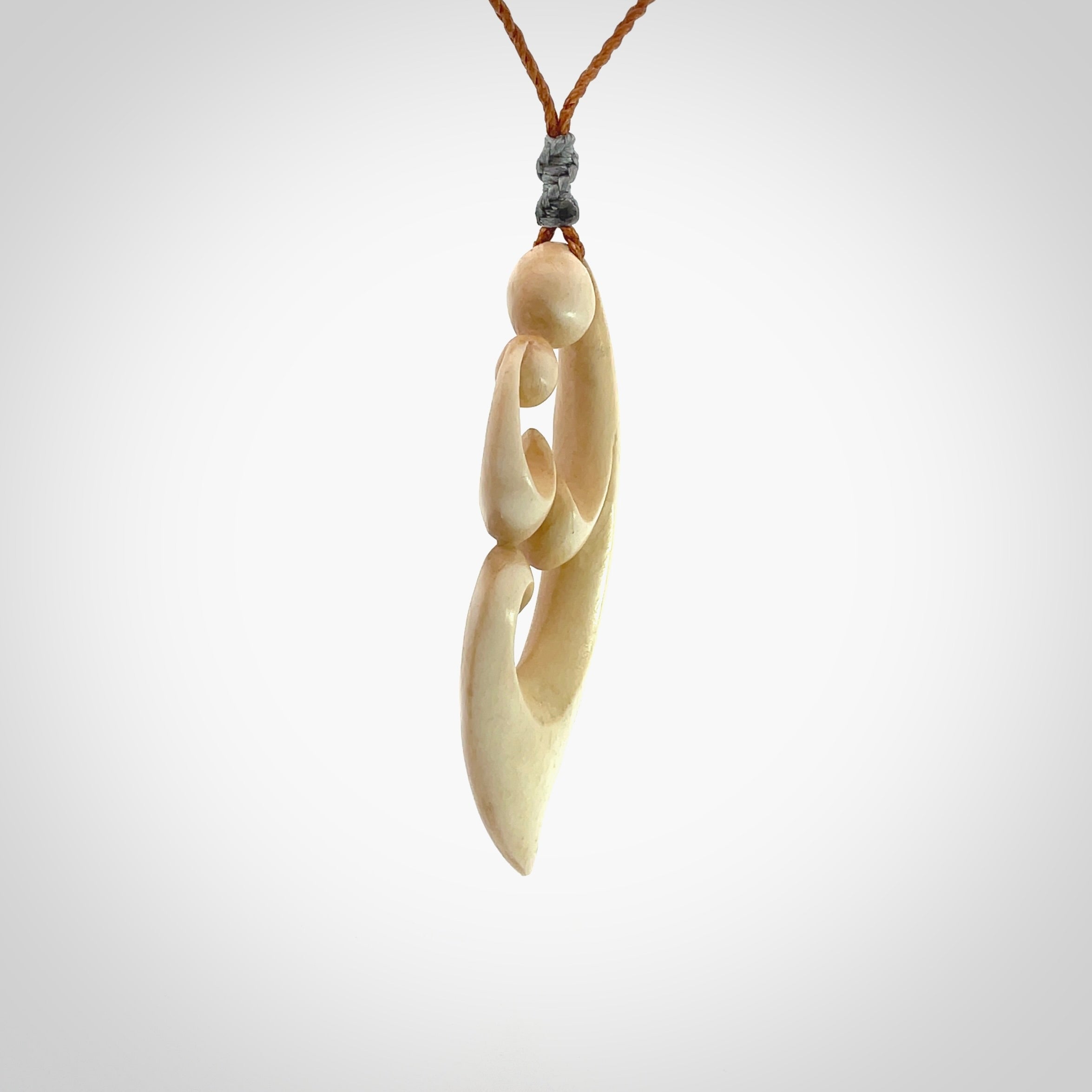 A hand carved masterpiece. A beautiful contemporary pendant carved from bone by Yuri Terenyi for NZ Pacific. This is a true piece of wearable art which is collectible. A one-off pendant representing a mother and child. Provided with an adjustable gingernut cord and packaged in a woven kete pouch.