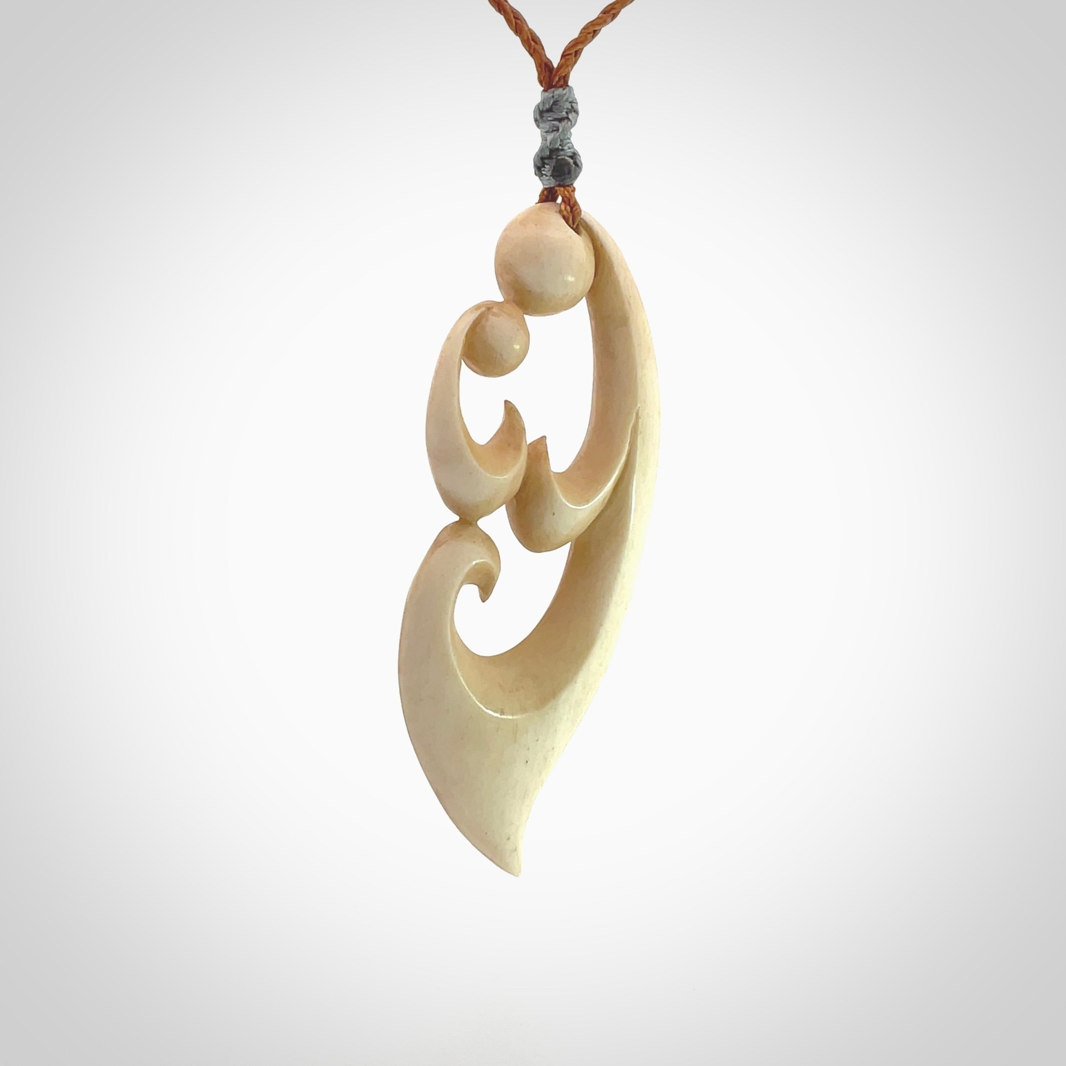 A hand carved masterpiece. A beautiful contemporary pendant carved from bone by Yuri Terenyi for NZ Pacific. This is a true piece of wearable art which is collectible. A one-off pendant representing a mother and child. Provided with an adjustable gingernut cord and packaged in a woven kete pouch.