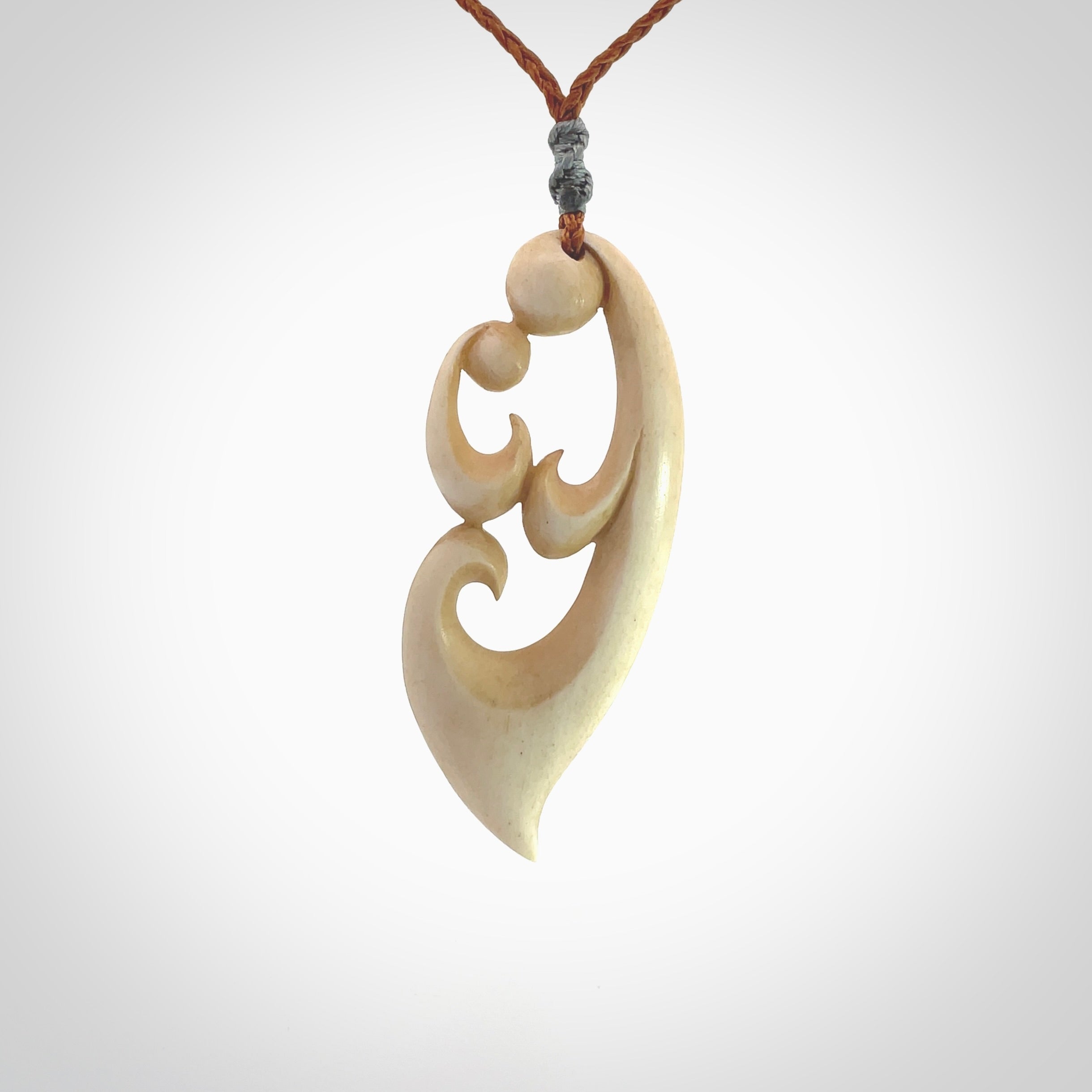 A hand carved masterpiece. A beautiful contemporary pendant carved from bone by Yuri Terenyi for NZ Pacific. This is a true piece of wearable art which is collectible. A one-off pendant representing a mother and child. Provided with an adjustable gingernut cord and packaged in a woven kete pouch.