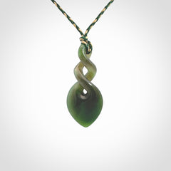 Hand carved New Zealand jade twist pendant. Carved in New Zealand by NZ Pacific. Unique double twist jewellery for sale online. Provided with an adjustable manuka green/kalahari cord.