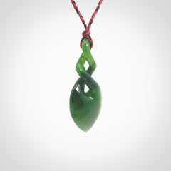 Hand carved New Zealand jade twist pendant. Carved in New Zealand by NZ Pacific. Unique double twist jewellery for sale online. Provided with an adjustable red/black cord.