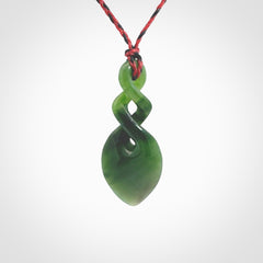 Hand carved New Zealand jade twist pendant. Carved in New Zealand by NZ Pacific. Unique double twist jewellery for sale online. Provided with an adjustable red/black cord.