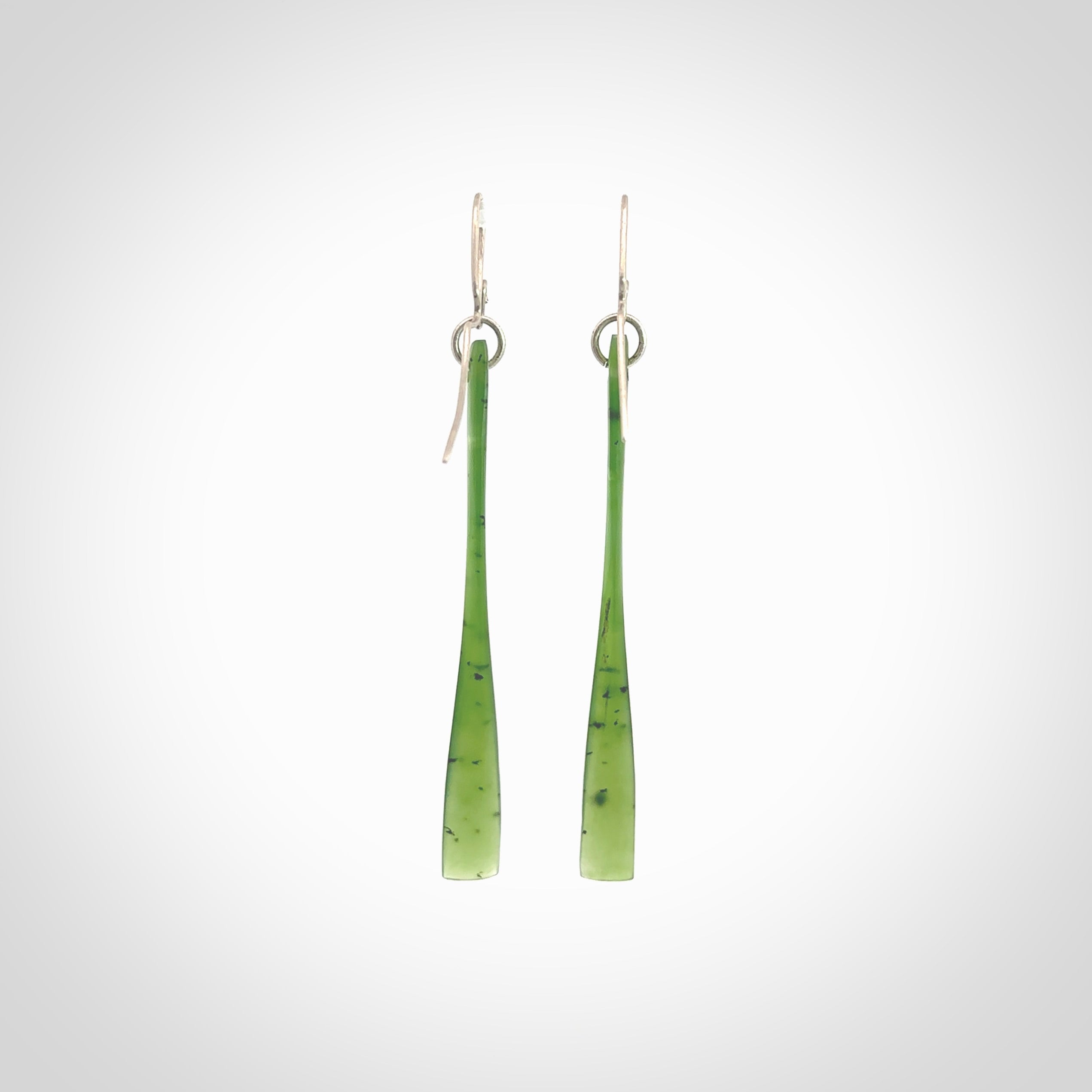 This picture shows hand carved New Zealand Jade, Pounamu paddle shaped, drop earrings. Delivery is free worldwide. NZ made Jade earrings. One pair only hand carved by New Zealand artist, Nicola Rees.