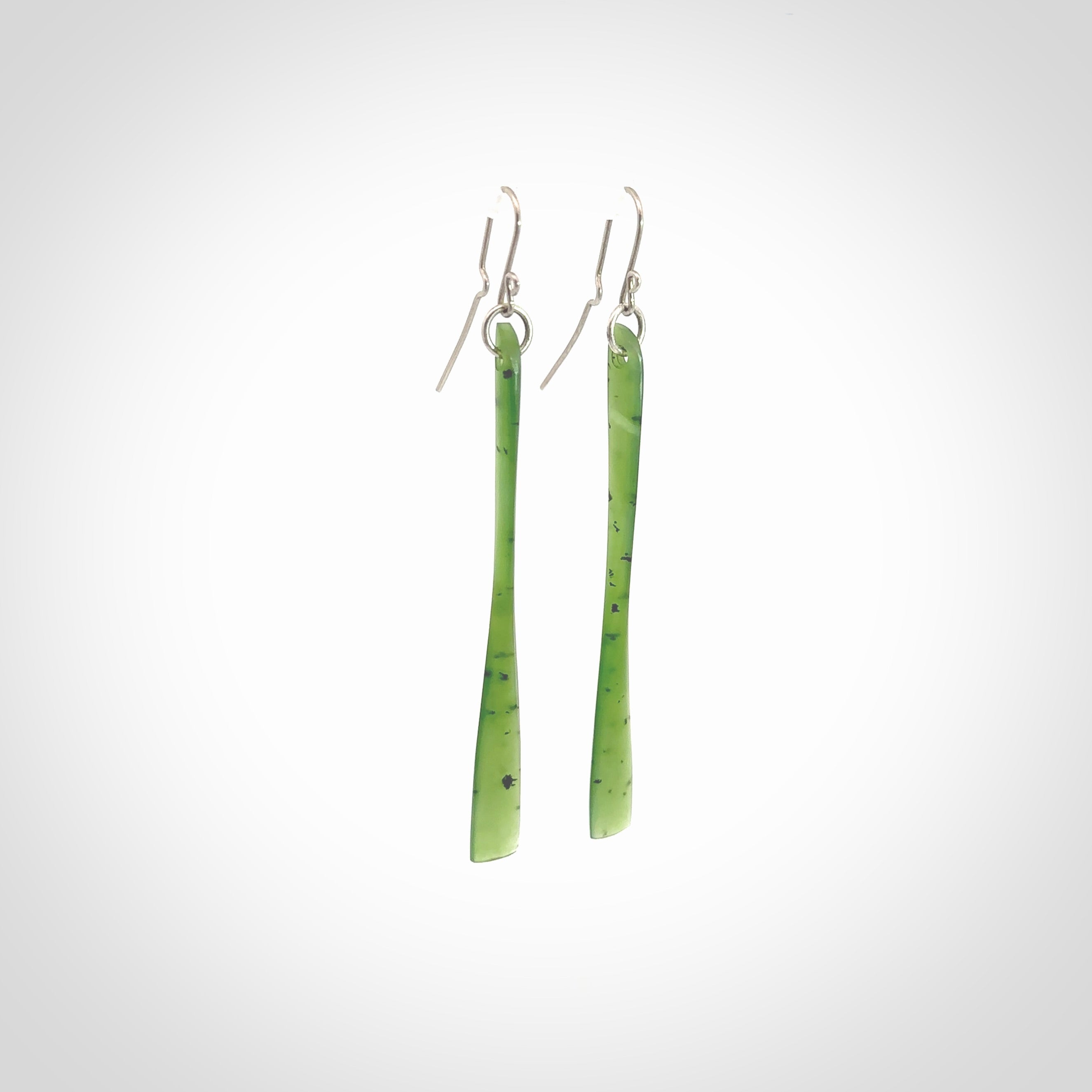 This picture shows hand carved New Zealand Jade, Pounamu paddle shaped, drop earrings. Delivery is free worldwide. NZ made Jade earrings. One pair only hand carved by New Zealand artist, Nicola Rees.