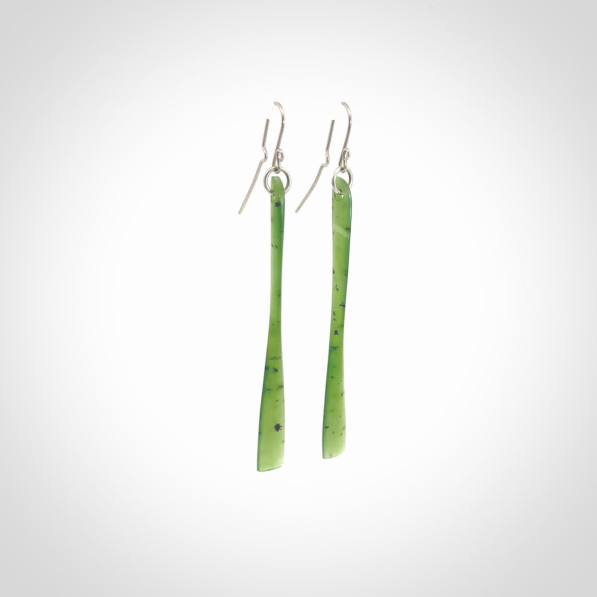 This picture shows hand carved New Zealand Jade, Pounamu paddle shaped, drop earrings. Delivery is free worldwide. NZ made Jade earrings. One pair only hand carved by New Zealand artist, Nicola Rees.