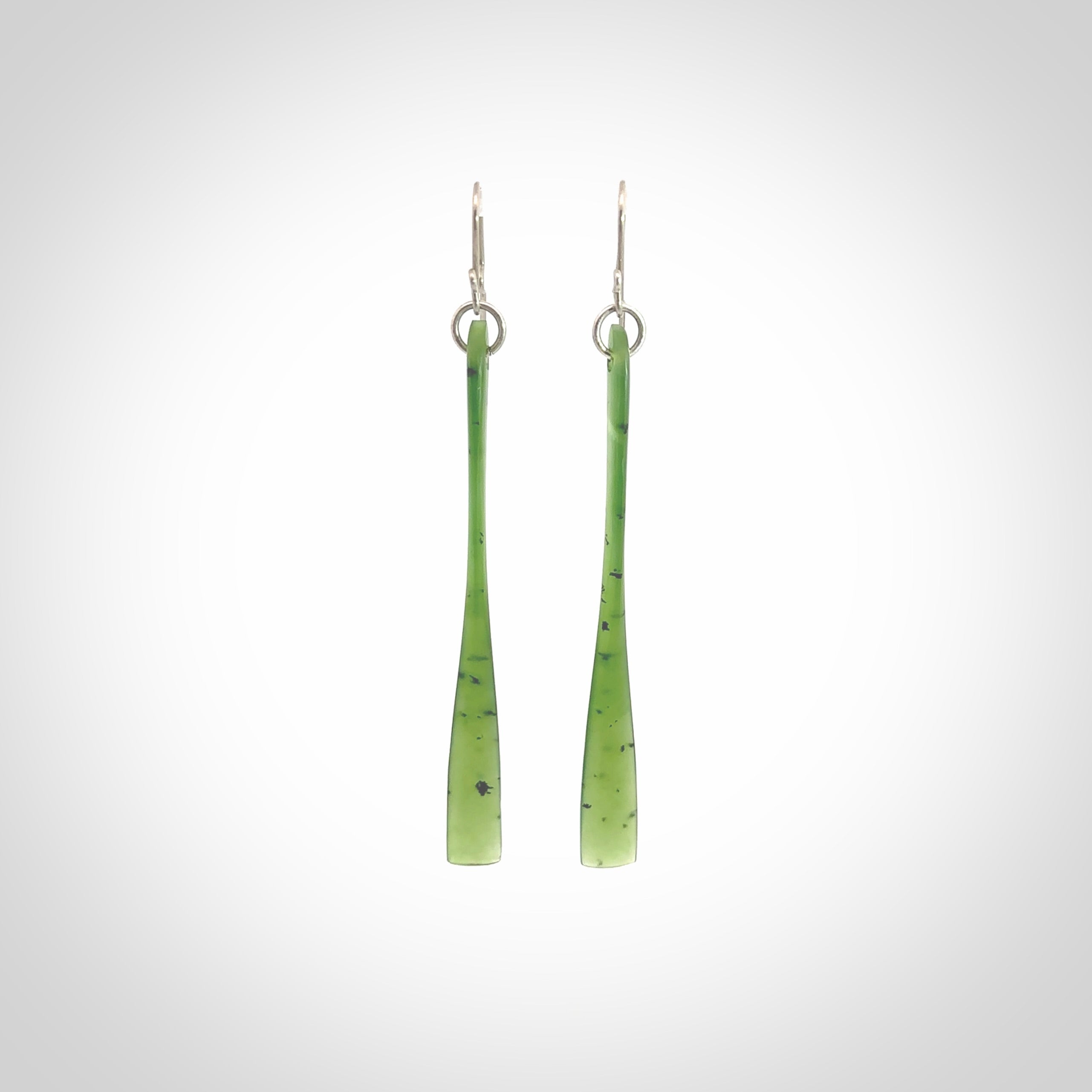 This picture shows hand carved New Zealand Jade, Pounamu paddle shaped, drop earrings. Delivery is free worldwide. NZ made Jade earrings. One pair only hand carved by New Zealand artist, Nicola Rees.