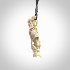 Hand carved deer antler, bone skeleton lying on its side pendant online for sale. Creative necklace for lovers of skeletons hand made from deer antler, bone. Free shipping worldwide. We provide this pendant with an adjustable cord.