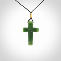 Hand carved New Zealand jade cross necklace. Religious symbol pendant. Christian cross pendant for sale online. Hand crafted from New Zealand Jade Pounamu, free worldwide delivery.