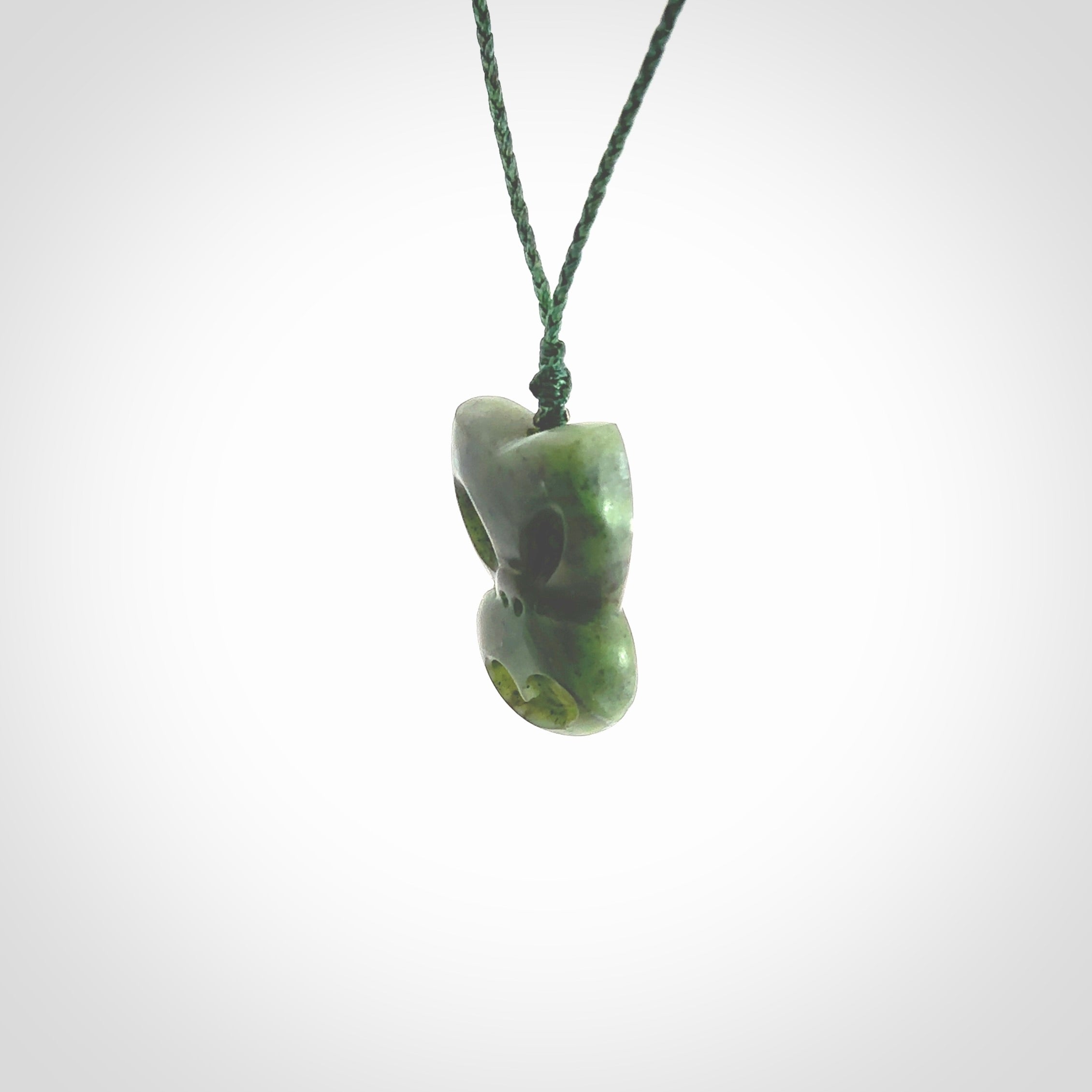 Hand carved New Zealand Jade Pounamu Wheku face pendant. Carved from New Zealand Jade by NZ Pacific. Hand crafted Jade jewellery for sale online. Pacific carving pendant, striking and unique delivered to you with Express Courier at no extra cost.