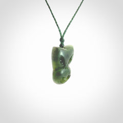 Hand carved New Zealand Jade Pounamu Wheku face pendant. Carved from New Zealand Jade by NZ Pacific. Hand crafted Jade jewellery for sale online. Pacific carving pendant, striking and unique delivered to you with Express Courier at no extra cost.