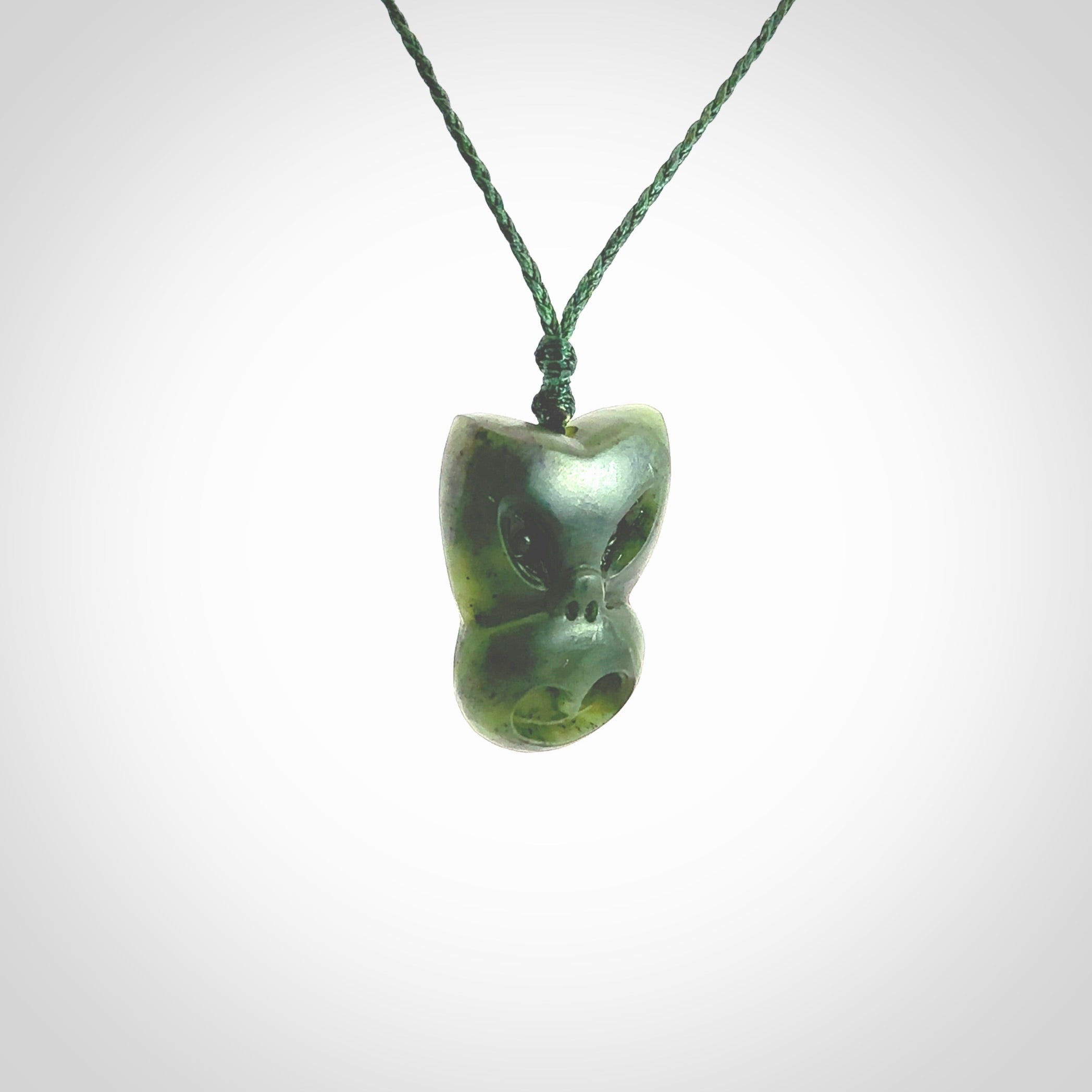 Hand carved New Zealand Jade Pounamu Wheku face pendant. Carved from New Zealand Jade by NZ Pacific. Hand crafted Jade jewellery for sale online. Pacific carving pendant, striking and unique delivered to you with Express Courier at no extra cost.