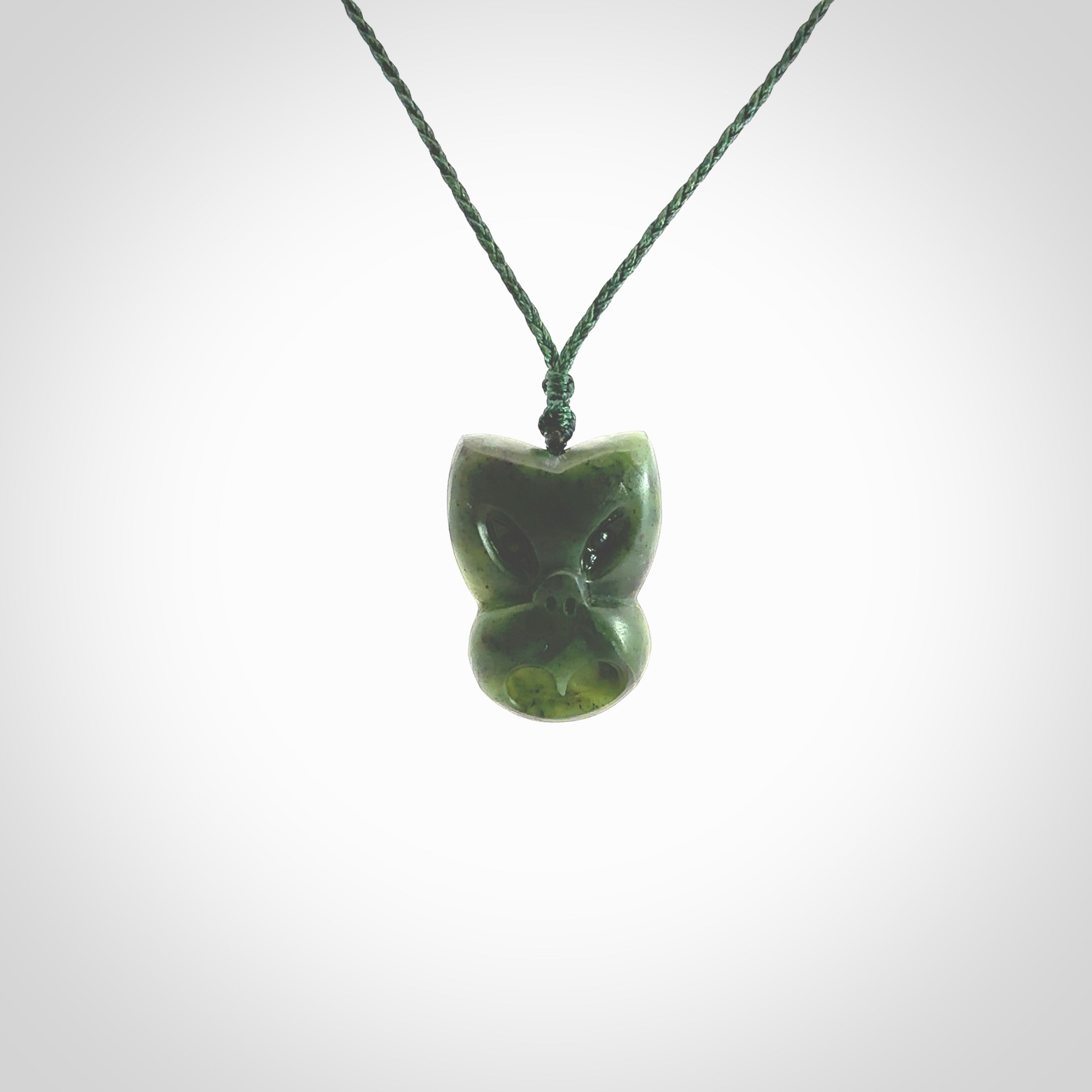 Hand carved New Zealand Jade Pounamu Wheku face pendant. Carved from New Zealand Jade by NZ Pacific. Hand crafted Jade jewellery for sale online. Pacific carving pendant, striking and unique delivered to you with Express Courier at no extra cost.