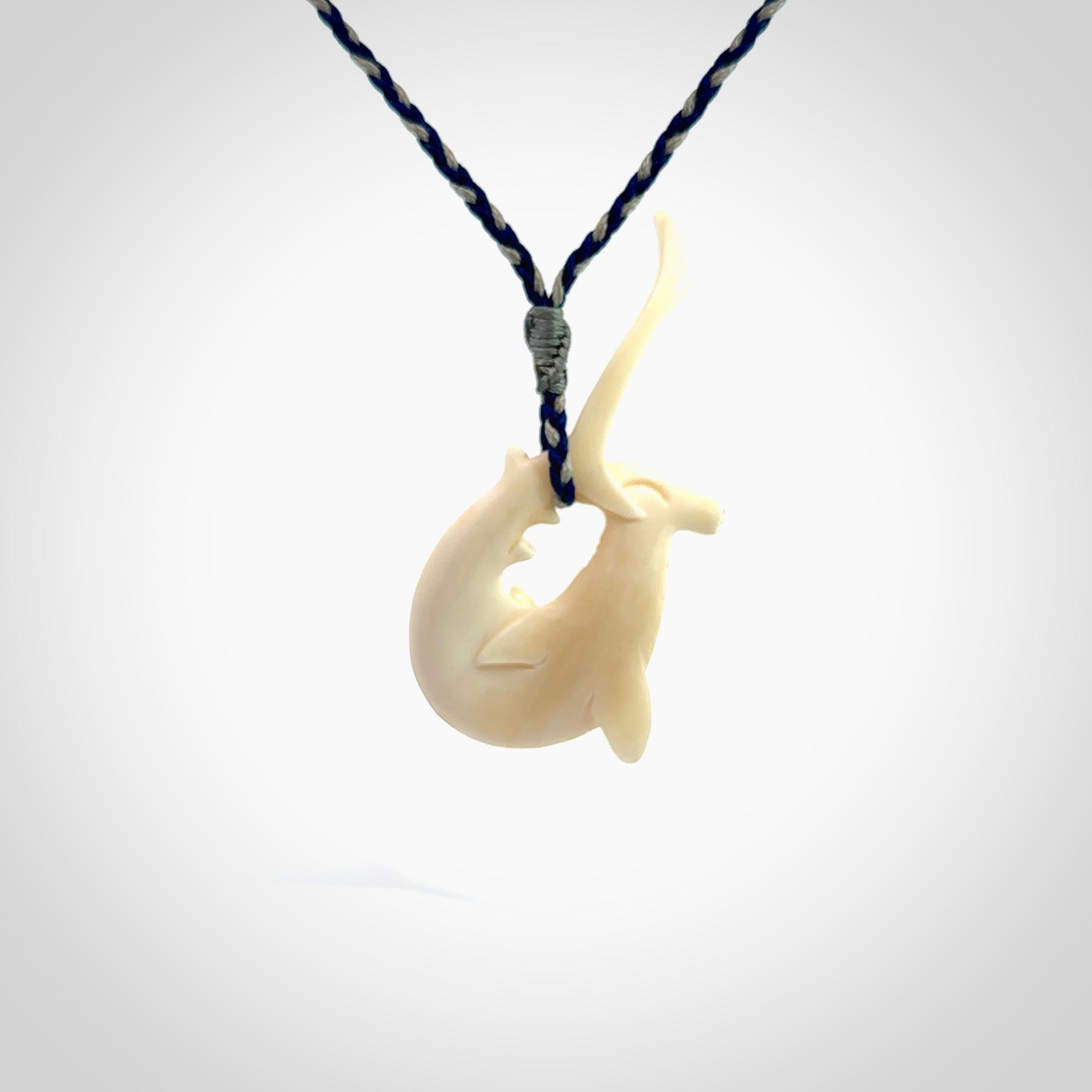 Hand carved hammerhead shark pendant. Carved in natural bone. Moana pendants for sale online.