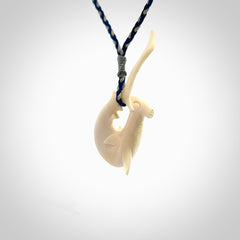 Hand carved hammerhead shark pendant. Carved in natural bone. Moana pendants for sale online.