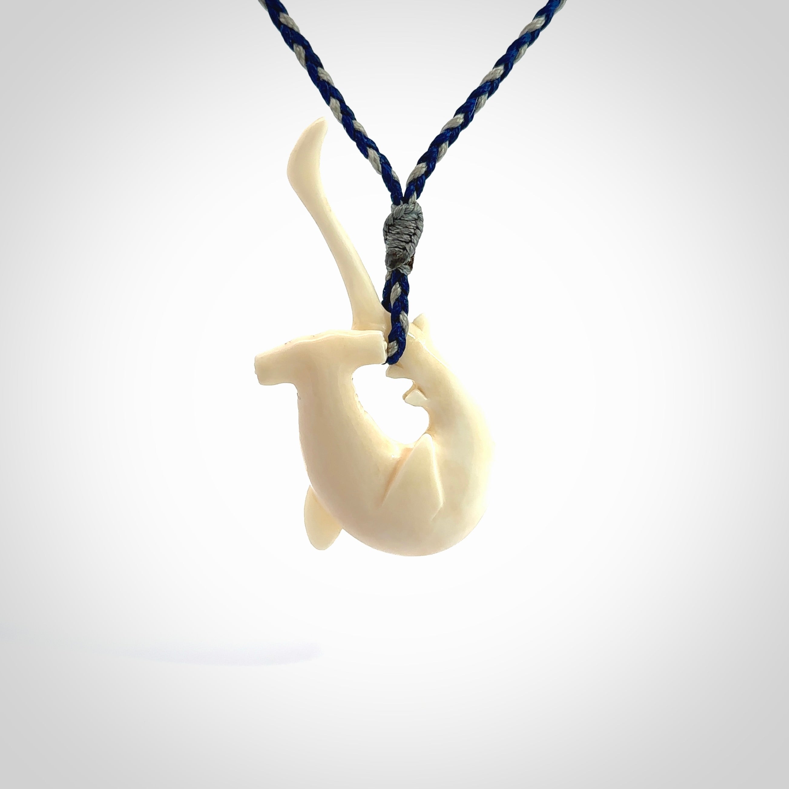 Hand carved hammerhead shark pendant. Carved in natural bone. Moana pendants for sale online.