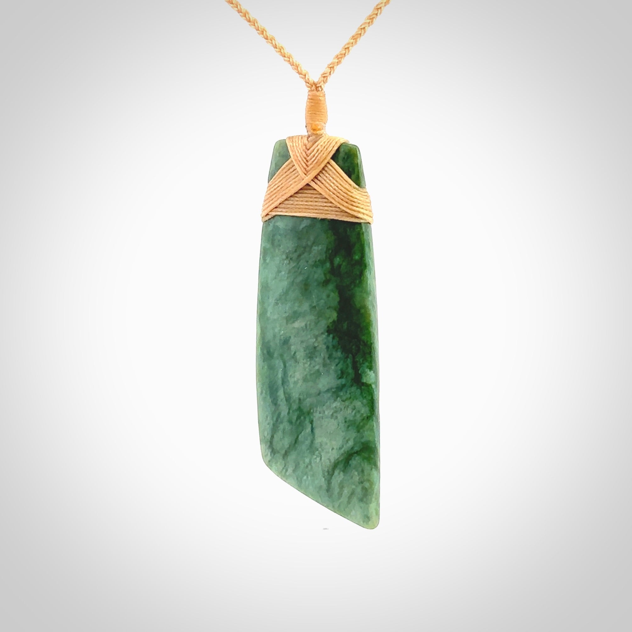 Hand carved from a lovely piece of local New Zealand Jade. The quality of the workmanship and design is outstanding - this is a piece you will want to wear all the time. We have suspended this from a 4-plait beige cord which can be adjusted with a couple of slip knots and beige binding. Hand made by Kyohei Noguchi.