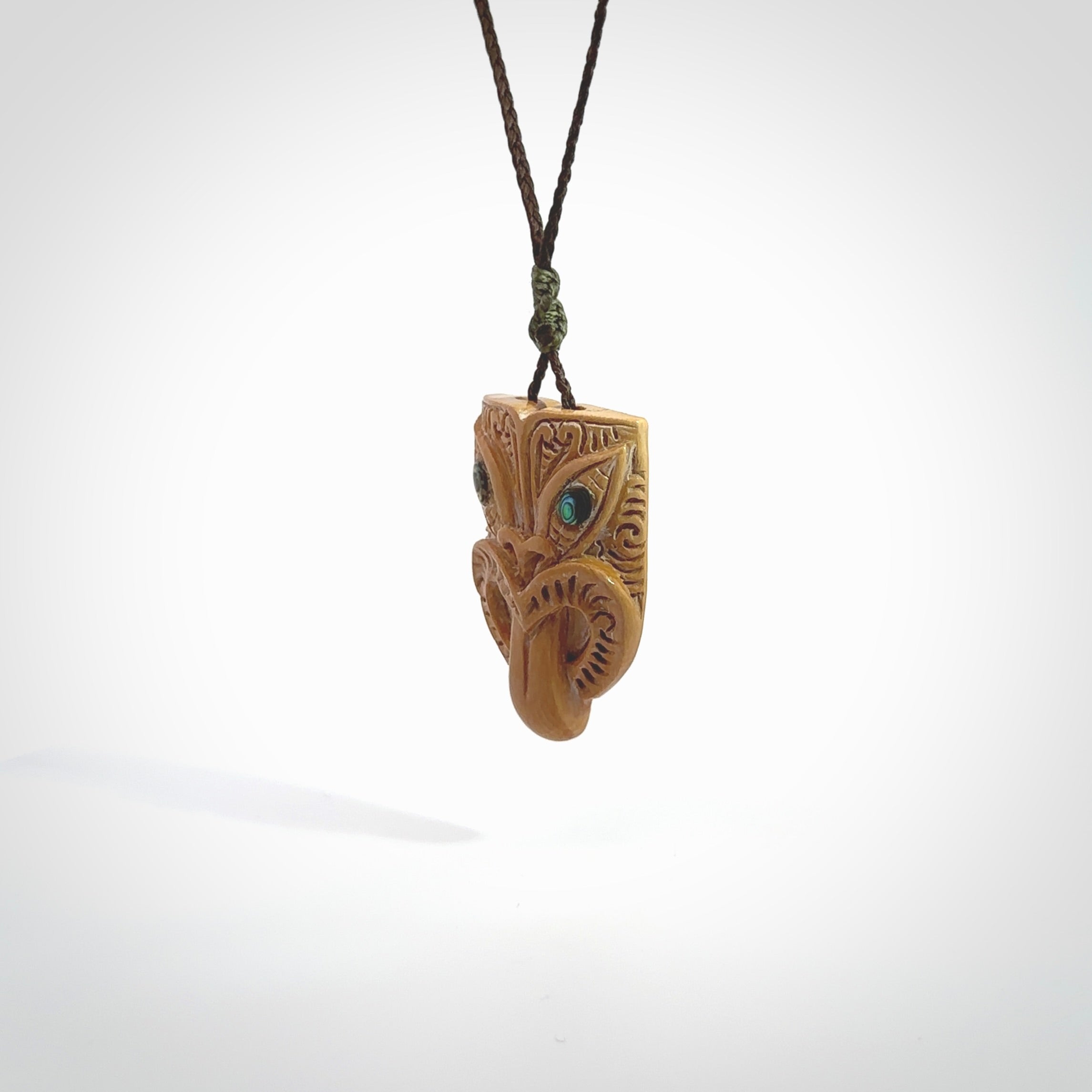 Hand carved Wheku pendant. Carved from woolly mammoth Tusk by NZ Pacific. Hand crafted Mammoth tusk jewellery for sale online. Provided with an adjustable cord and packaged in woven kete pouch