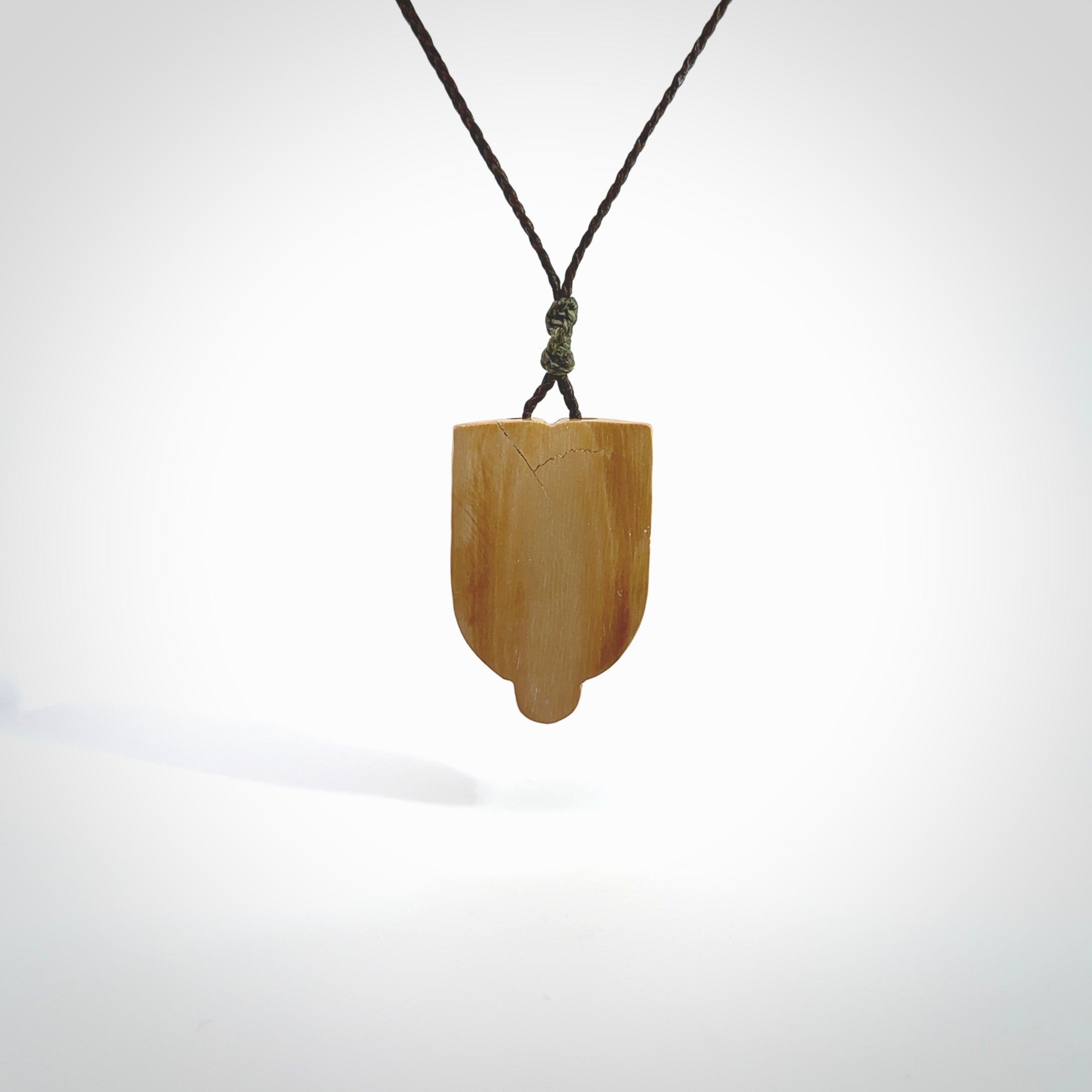 Hand carved Wheku pendant. Carved from woolly mammoth Tusk by NZ Pacific. Hand crafted Mammoth tusk jewellery for sale online. Provided with an adjustable cord and packaged in woven kete pouch