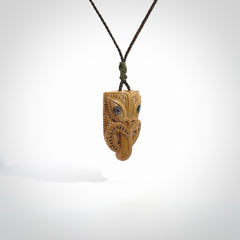 Hand carved Wheku pendant. Carved from woolly mammoth Tusk by NZ Pacific. Hand crafted Mammoth tusk jewellery for sale online. Provided with an adjustable cord and packaged in woven kete pouch