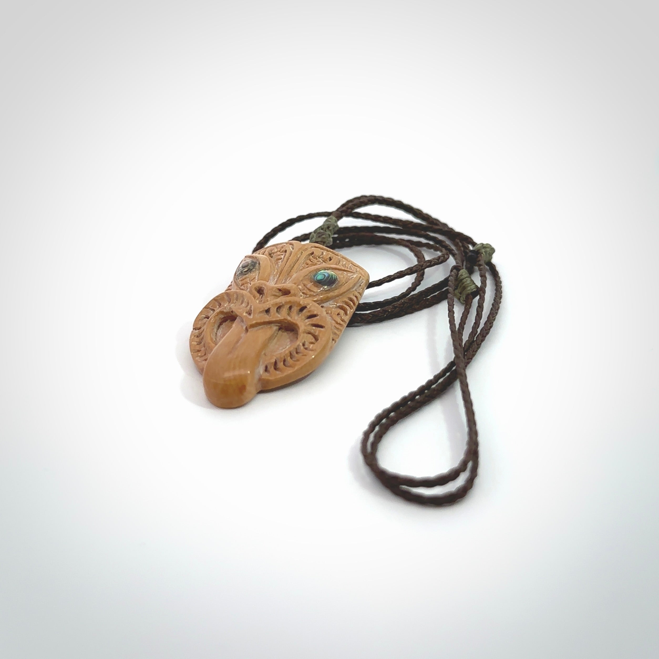 Hand carved Wheku pendant. Carved from woolly mammoth Tusk by NZ Pacific. Hand crafted Mammoth tusk jewellery for sale online. Provided with an adjustable cord and packaged in woven kete pouch