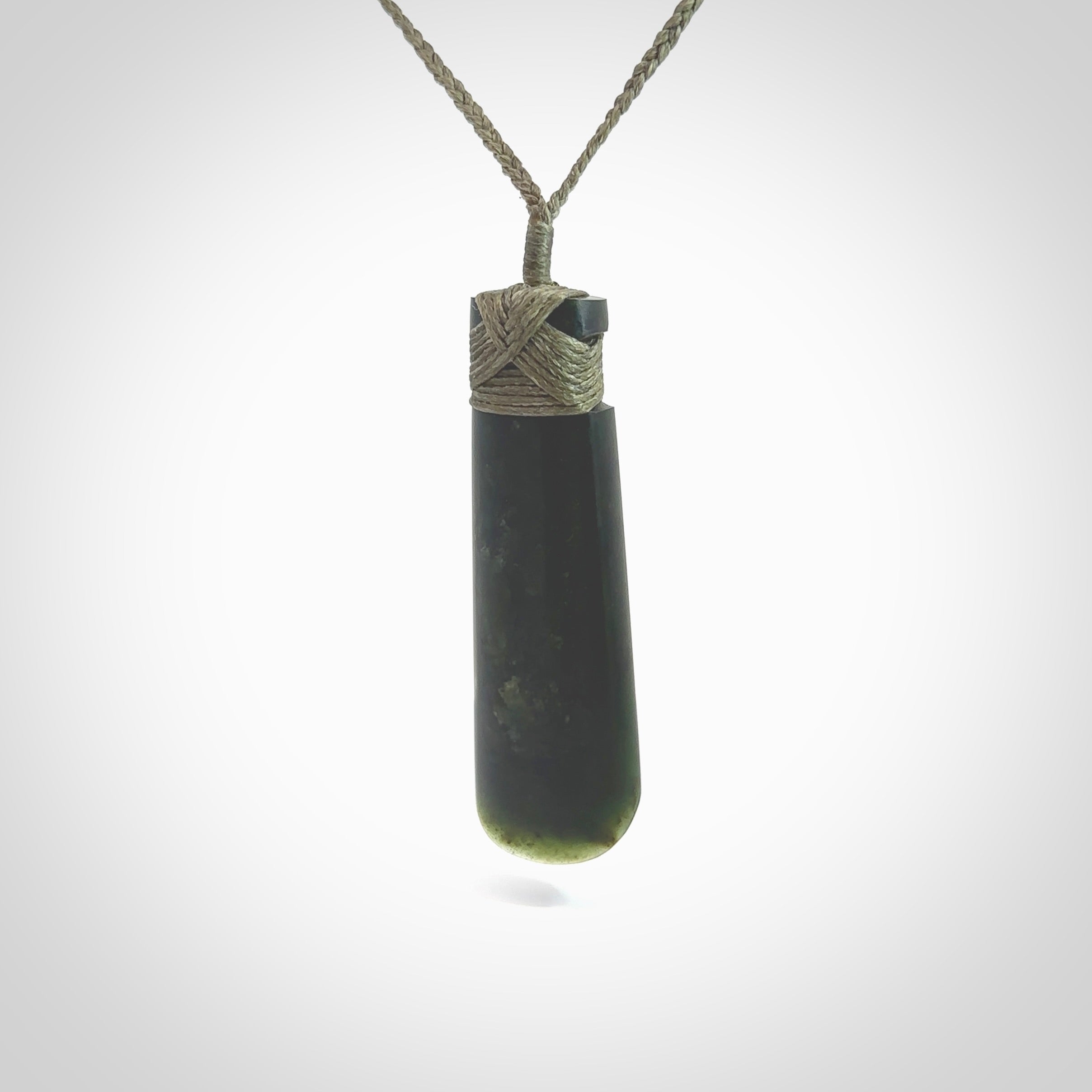 Hand made large New Zealand Kawakawa jade toki pendant. Hand carved in New Zealand by Rueben Tipene. Hand made jewellery. Unique large Jade Toki with adjustable cord. Free shipping worldwide.