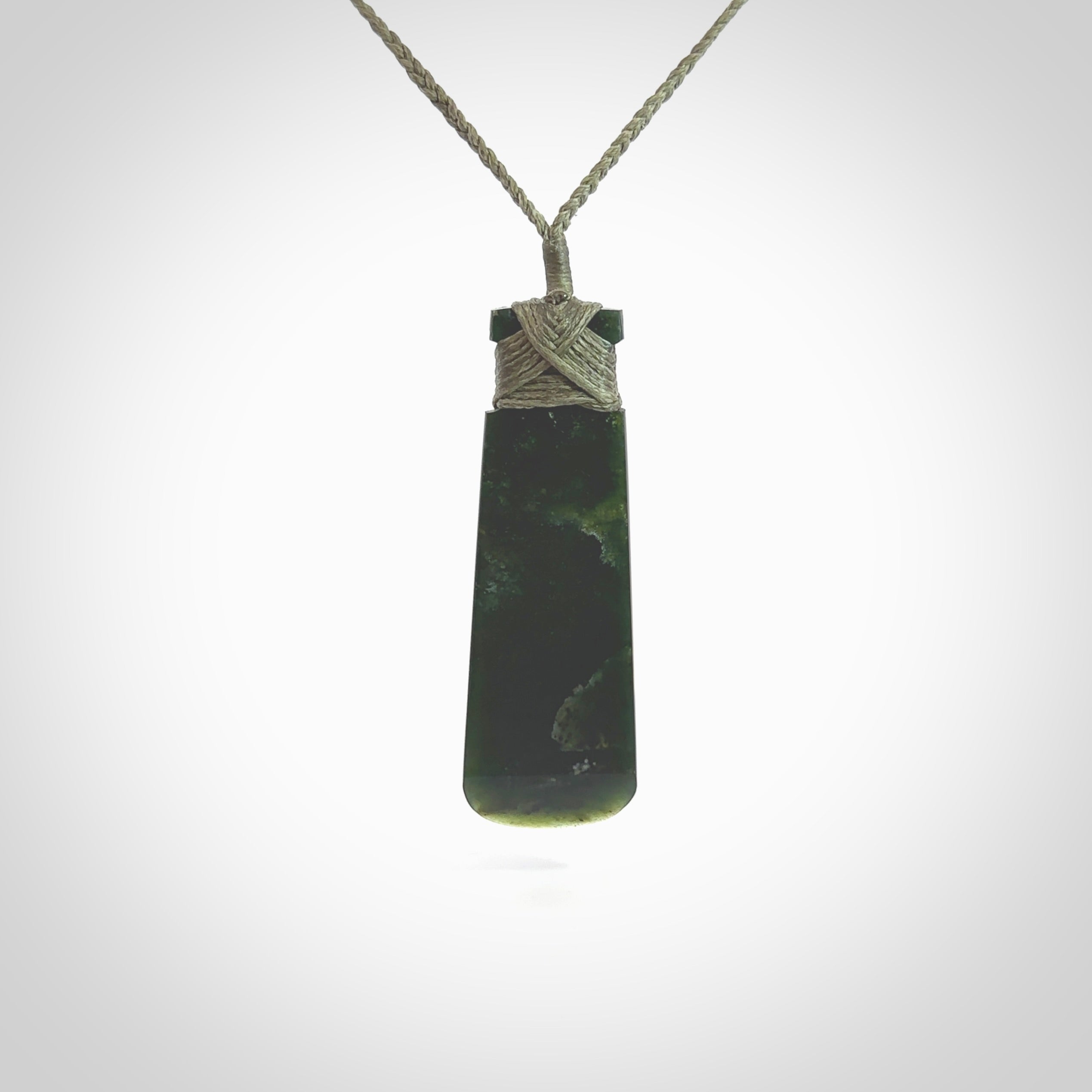 Hand made large New Zealand Kawakawa jade toki pendant. Hand carved in New Zealand by Rueben Tipene. Hand made jewellery. Unique large Jade Toki with adjustable cord. Free shipping worldwide.