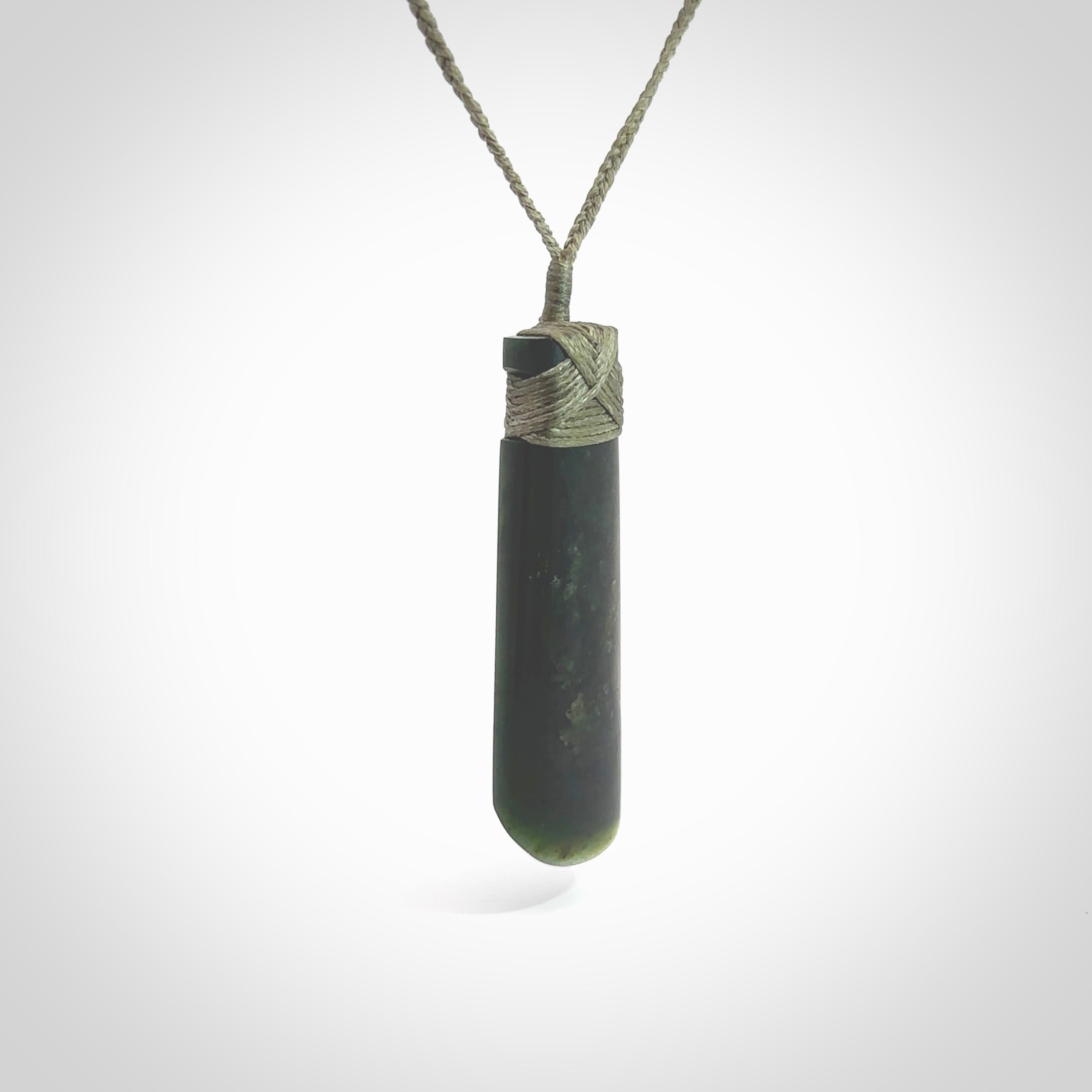 Hand made large New Zealand Kawakawa jade toki pendant. Hand carved in New Zealand by Rueben Tipene. Hand made jewellery. Unique large Jade Toki with adjustable cord. Free shipping worldwide.