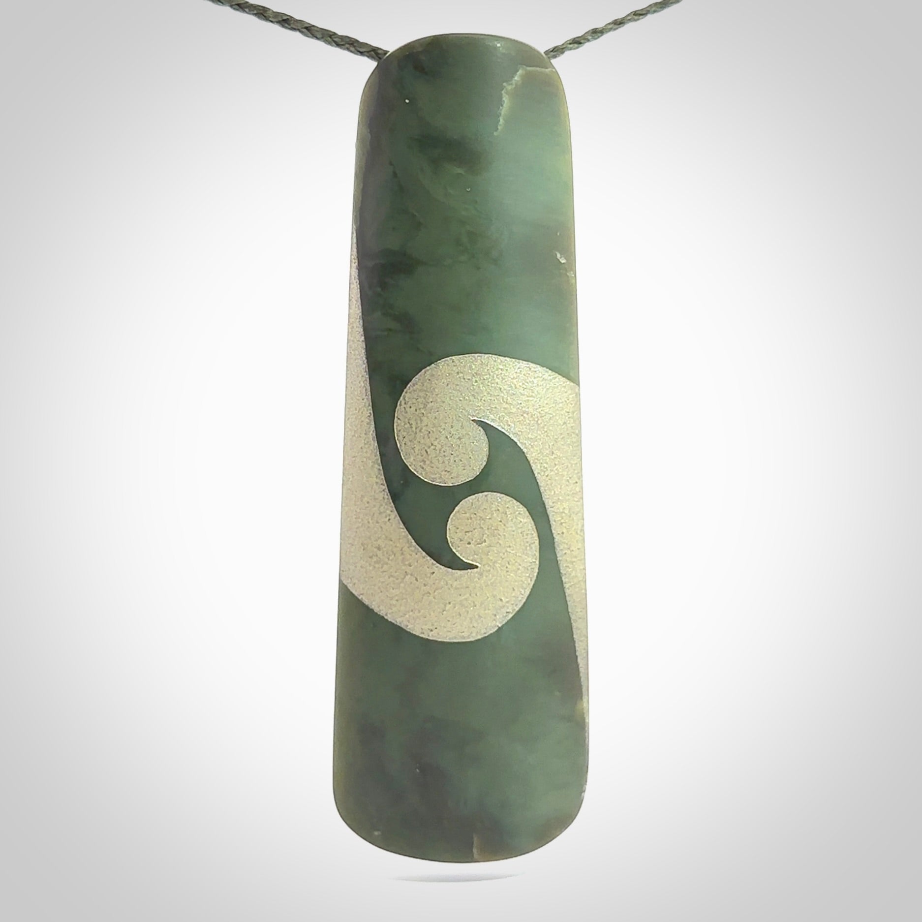 This photo shows a large jade drop shaped pendant. It a a lovely, colourful Inanga jade. The cord is a green colour and is adjustable in length. One only large, contemporary drop necklace from Jade, by Rueben Tipene.