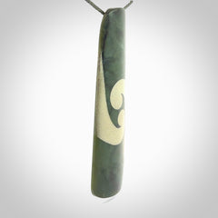 This photo shows a large jade drop shaped pendant. It a a lovely, colourful Inanga jade. The cord is a green colour and is adjustable in length. One only large, contemporary drop necklace from Jade, by Rueben Tipene.