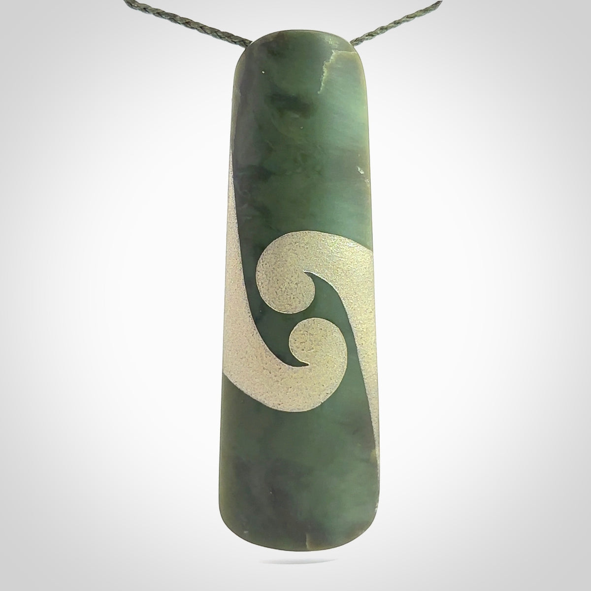 This photo shows a large jade drop shaped pendant. It a a lovely, colourful Inanga jade. The cord is a green colour and is adjustable in length. One only large, contemporary drop necklace from Jade, by Rueben Tipene.